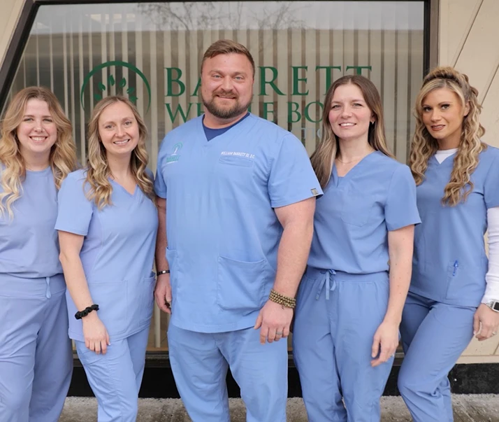 Chiropractor Pleasant Hills PA William Barrett With Staff Blue Scrubs 2026